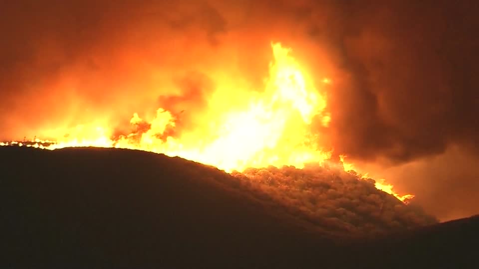 Residents flee as wildfire threatens homes in foothills near Los Angeles