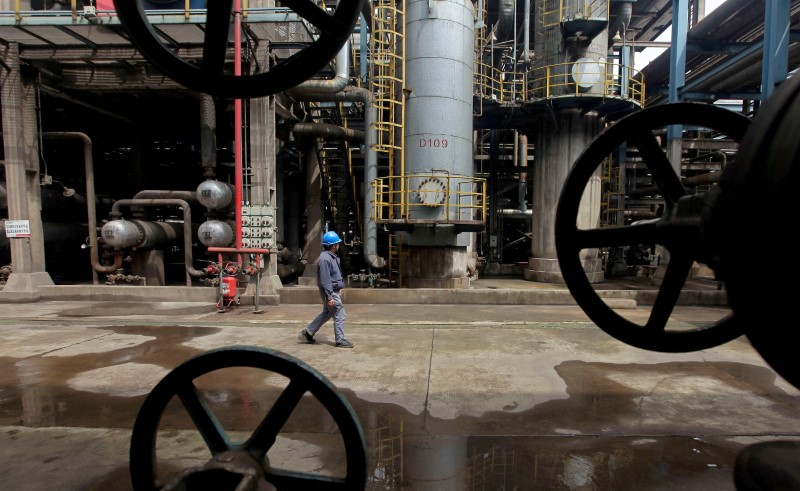 Oil rises slightly, but growing global supply a worry