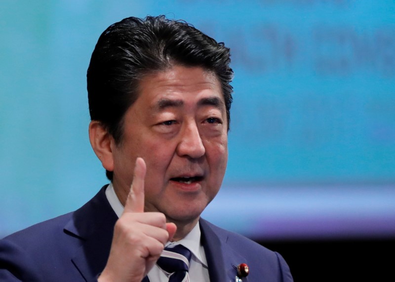 Japan’s Abe urges central bank’s Kuroda to keep up efforts on economy