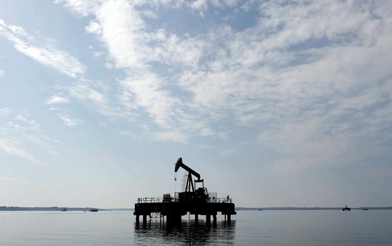 Oil settles higher, posts weekly gain as weak dollar underpins