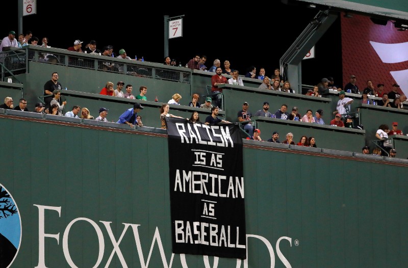Campaigners unveil banner linking racism and baseball at Red Sox game