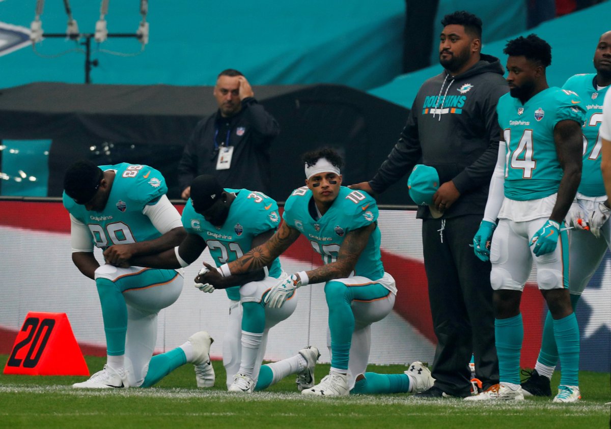 Three Miami Dolphins players defy Trump order to stand during anthem