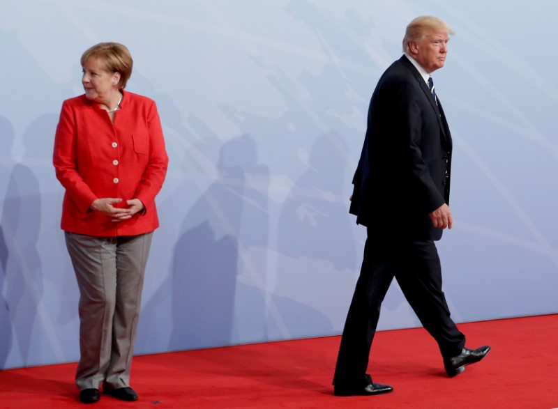 Faced with U.S. tax cuts, France, Germany hasten harmonization: Merkel