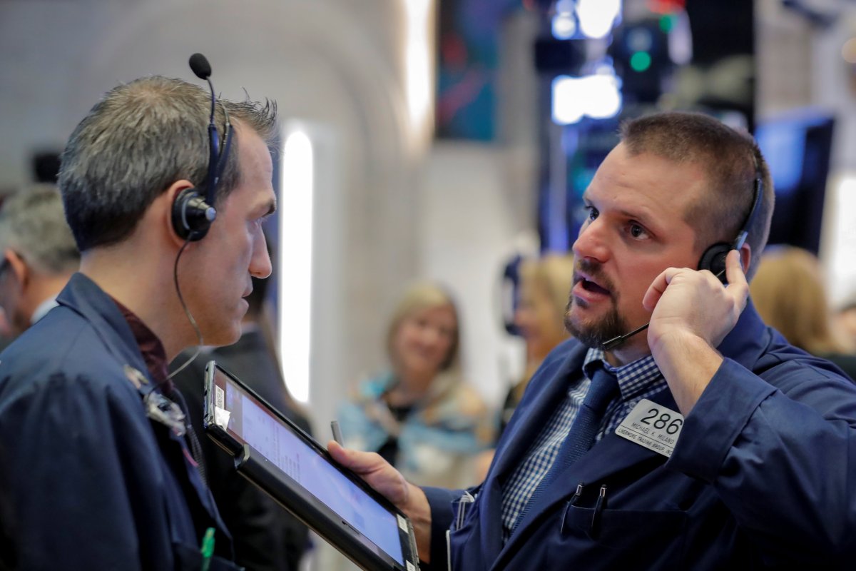 Wall Street hit by weak industrial earnings, hawkish Fed