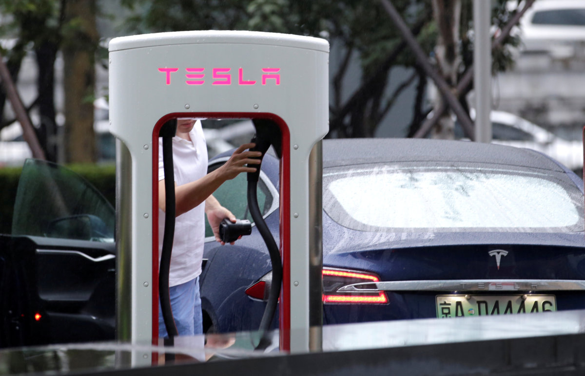 Tesla cuts China car prices to absorb hit from trade war tariffs