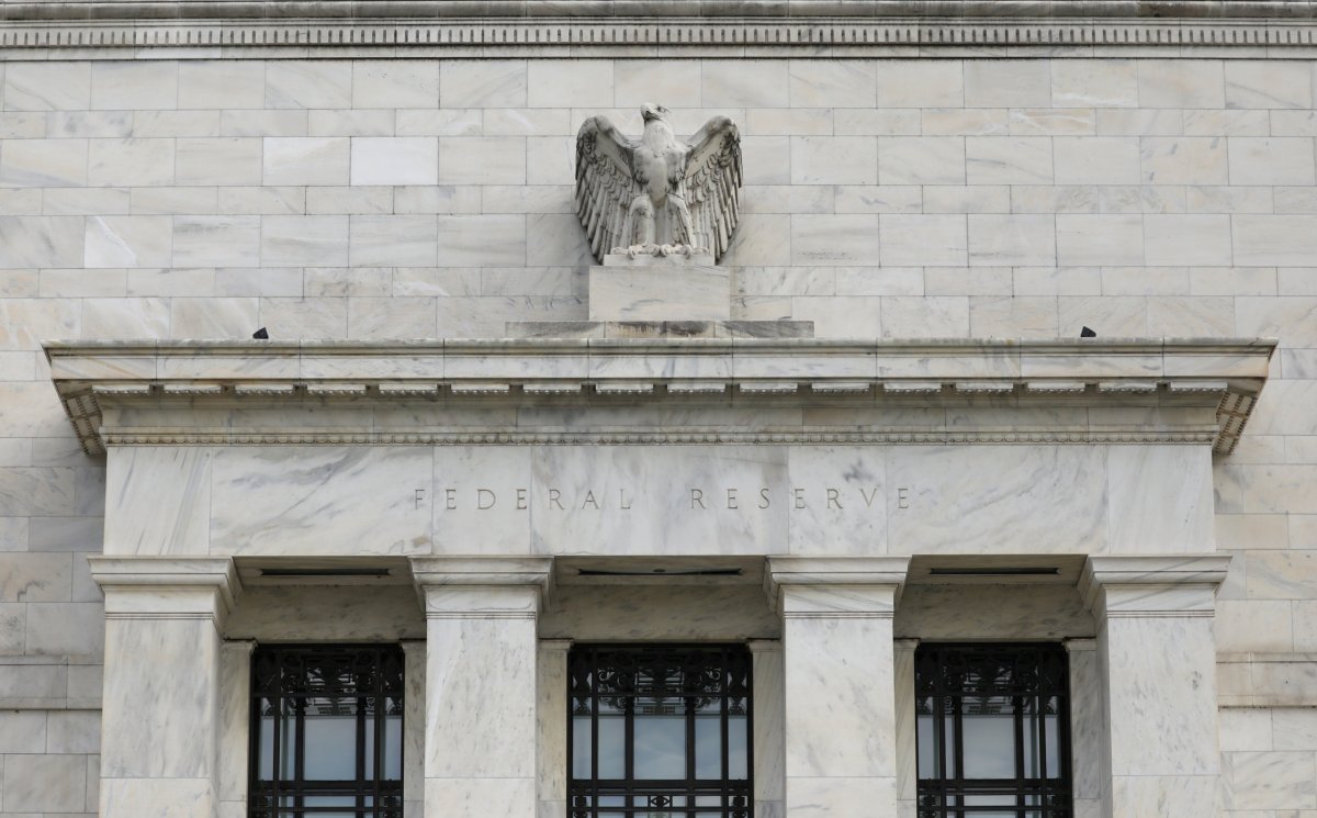 Fed says contacts worry about trade war; economy growing modestly