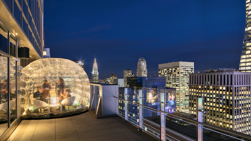 Huddle up inside a rooftop bubble for Midtown views from river to river at Bar 54.