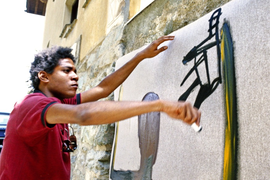Jean-Michael Basquiat may have died at age 27 in 1988, but the iconic New York City artist will soon live again on stage. The artist is seen above painting in in 1983 in St. Moritz, Switzerland. (Lee Jaffe/Getty Images)