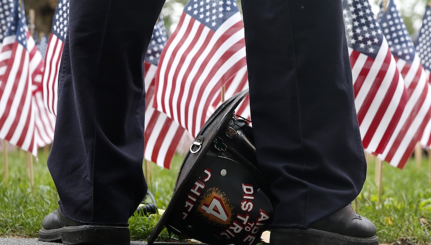 Firefighter John Varner of Boston's Engine 7 pays respects at the 9/11 memorial on the Boston Public Garden to mark the 15th anniversary on Sept. 11, 2016. Photo: Getty Images