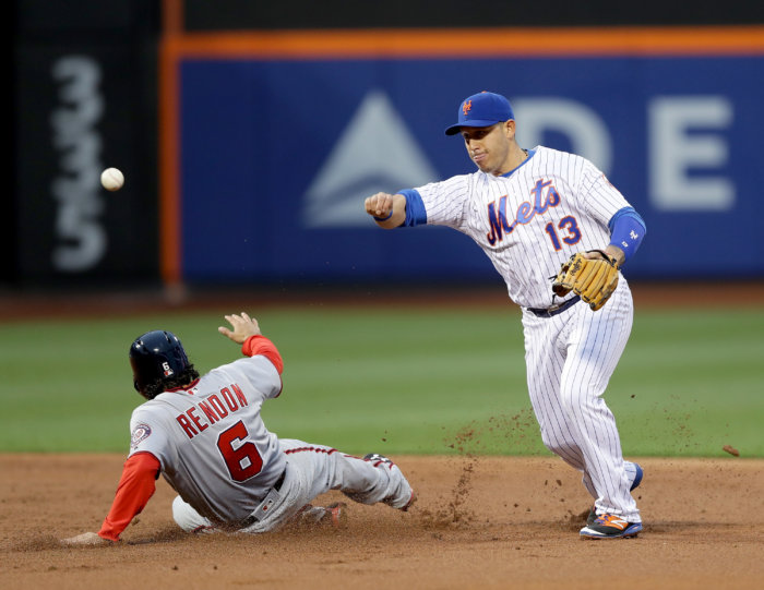Mets shortstop Asdrubal Cabrera turns a double play against the Nationals. (Getty Images)