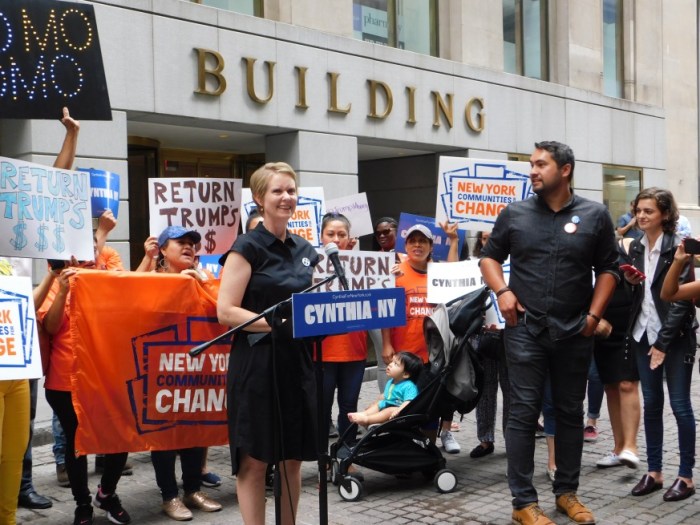 Cuomo challenger Cynthia Nixon rallied on Wall Street to urge the governor to return donations made between 2001-2009 by Donald Trump.