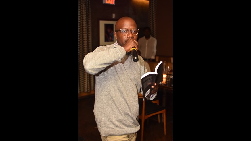David Ellis has been working in Harlem for the past 16 years, and the changing historic neighborhood inspired his latest poetry book, ‘Honey in Harlem.’ He is seen here reading at Ginny’s Supper club. (Kerby Jean)