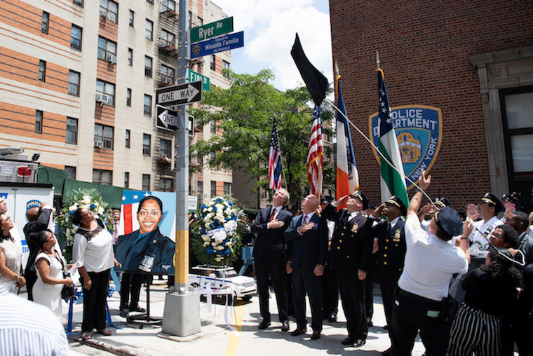 Mayor Bill de Blasio took a break from his Quebec vacation to take an NYPD plane to the one-year memorial for slain NYPD Detective Miosotis Familia.