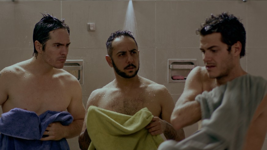 Three men stood in the shower