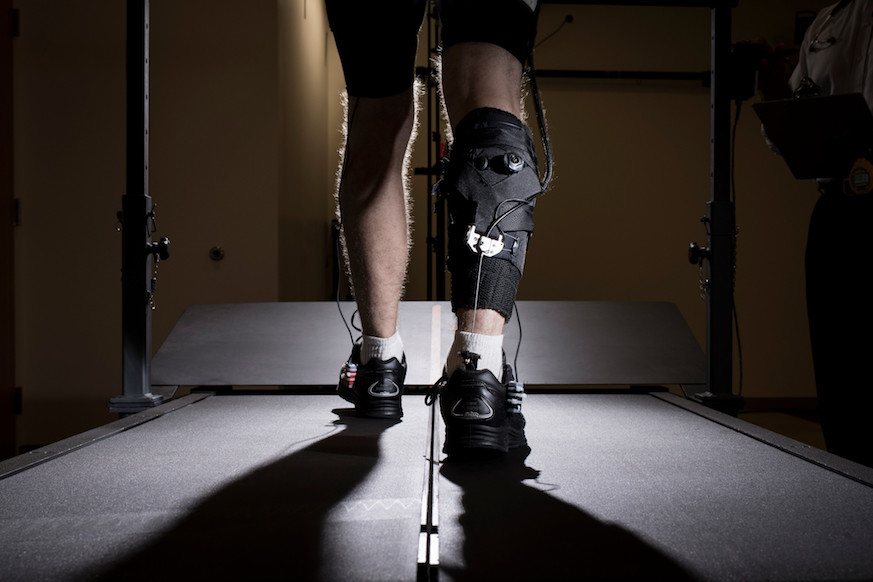 Researchers at Harvard and BU developed a robotic suit to help stroke patients walk normally again. Here, a patient tests the suit on a treadmill. Photo: Rolex Awards/Fred Merz