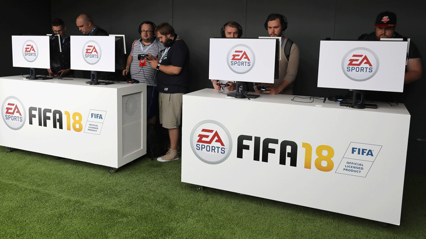 Consumers test out demos of EA Sports' "FIFA 18." (Photo: Getty Images)
