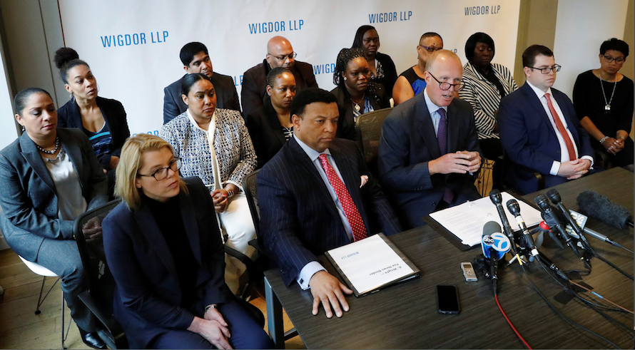 Attorney Douglas Wigdor, at far right, with Fox News host Kelly Wright, second from left, and fellow plaintiffs, discusses race discrimination class-action lawsuit filed on behalf of former and current employees, in New York, on Wednesday.