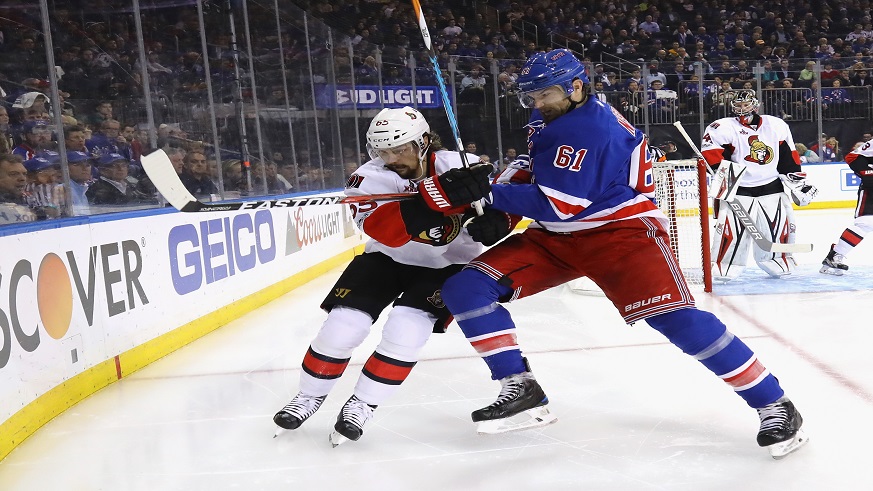 Senators defenseman Erik Karlsson (left) and Rangers winger Rick Nash (right) battle for a puck during Game 6 of the Eastern Conference semifinals. (Photo: Getty Images)