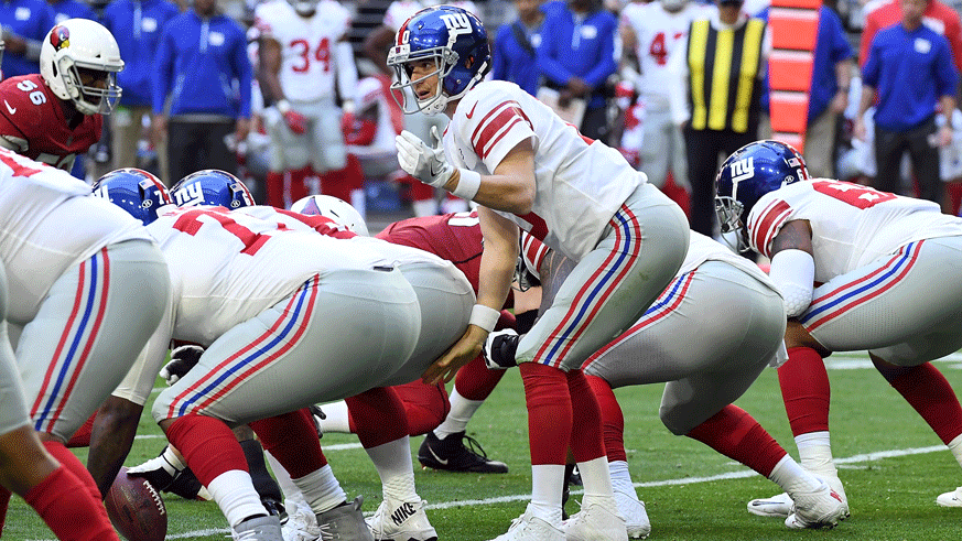 Eli Manning of the New York Giants behind his offensive line. (Photo: Getty Images)