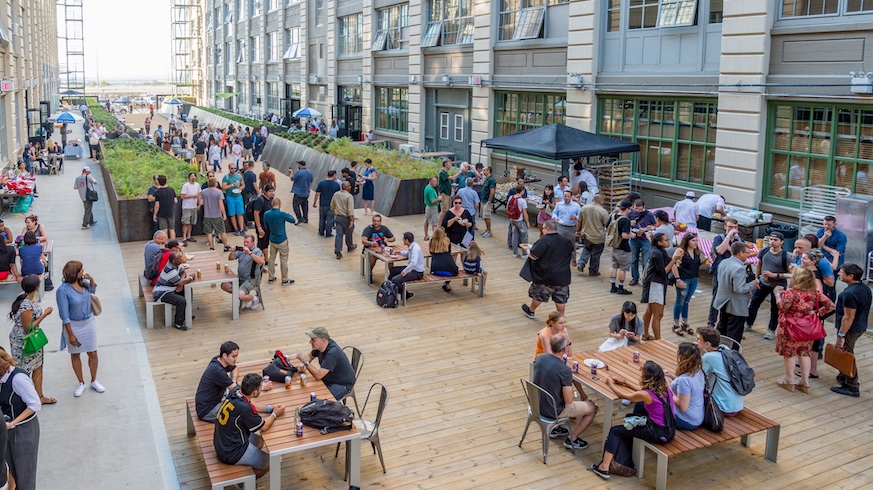 Industry City's spacious courtyards host games and live entertainment in addition to being a fab place to enjoy your future food hall eats. Credit: Provided