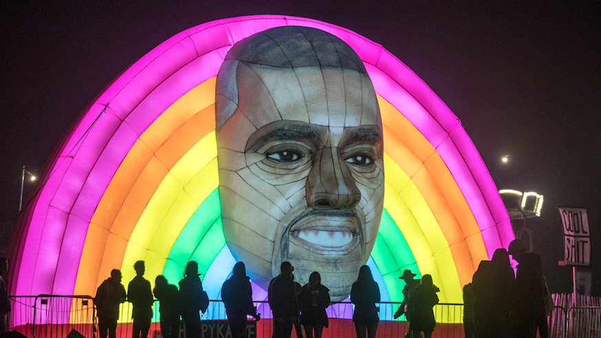 People pass a giant inflatable face of Kanye West on the first day of the Bestival festival being held at the Lulworth Estate on Sept. 7, 2017 in Dorset, England.