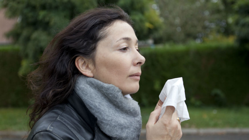 is the flu over woman sneezing
