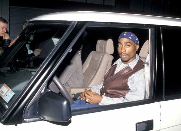 Tupac Shakur sitting in a car