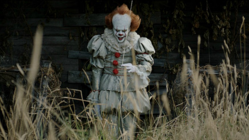 Pennywise The Dancing Clown stood in a field