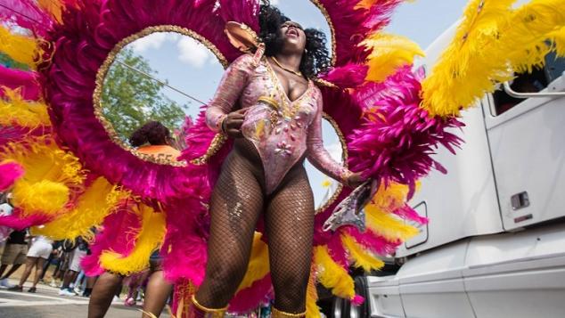 A costumed Jouvert reveler celebrates at the 2017 Boston Caribbean festival. Photo: Derek Kouyoumjian