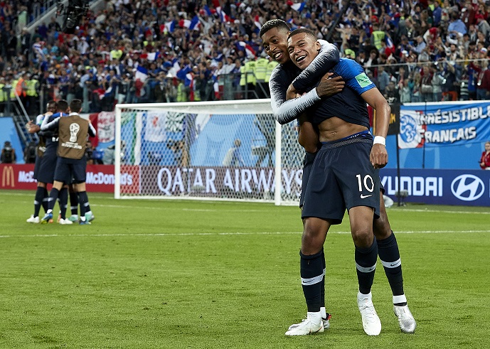 Kylian Mbappe celebrates with teammates at the World Cup semifinals.