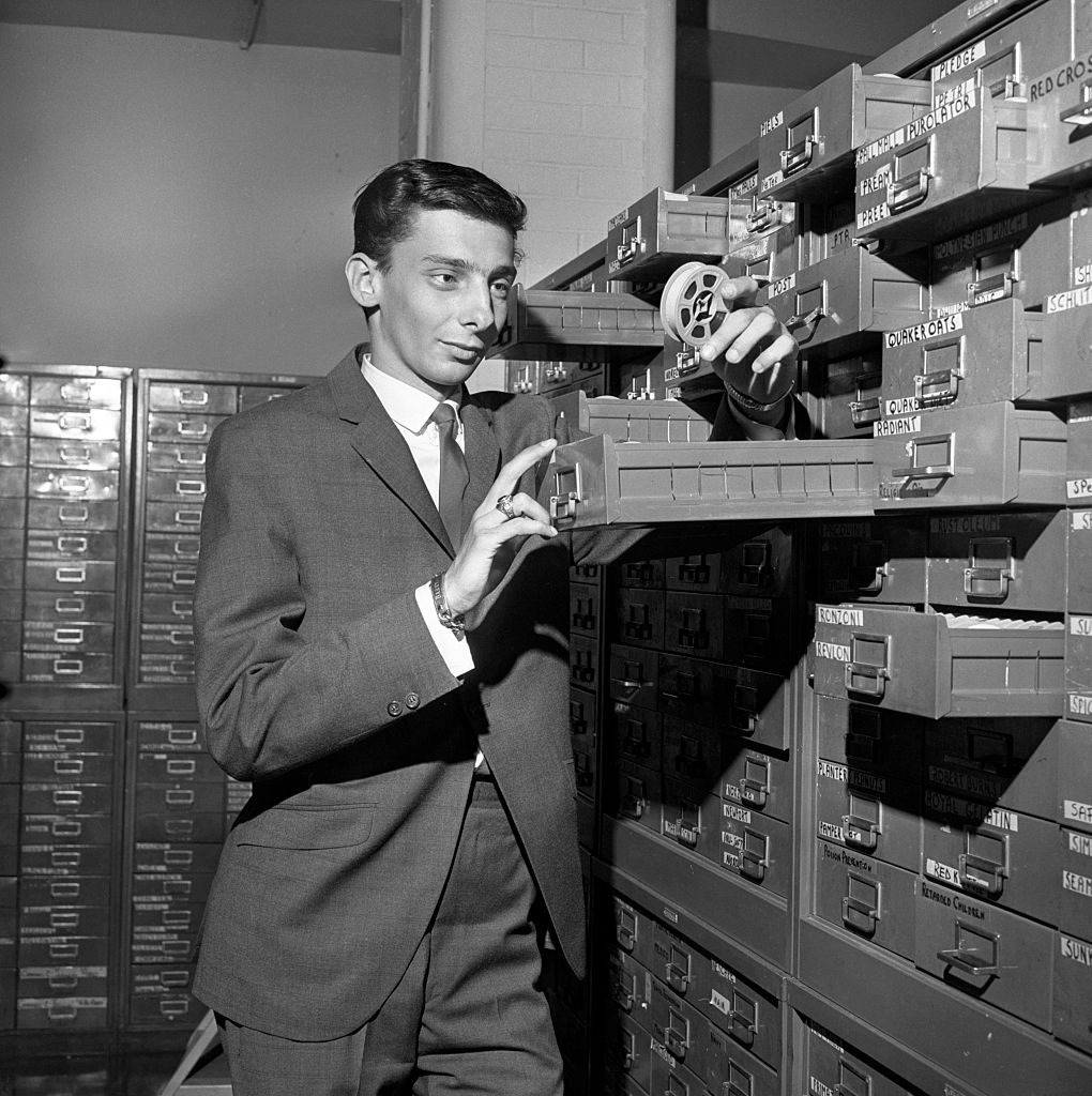 Barry Manilow paid his way through college by working as a clerk in a CBS file room in New York City, pictured there in 1965. | CBS via Getty Images