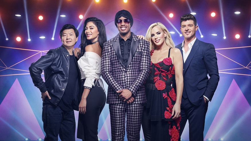 The Masked Singer host Nick Cannon poses with celebrity judges