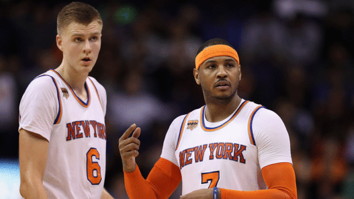 Knicks star Carmelo Anthony (right) discusses a play with teammate Kristaps Porzingis during the 2016-17 season. (Photo: Getty Images)