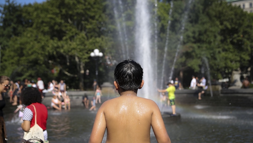 A boy cools himself at a fountain at Washington Square Park, but NYC cooling centers offer a dryer cooling experience. Photo: Getty Images