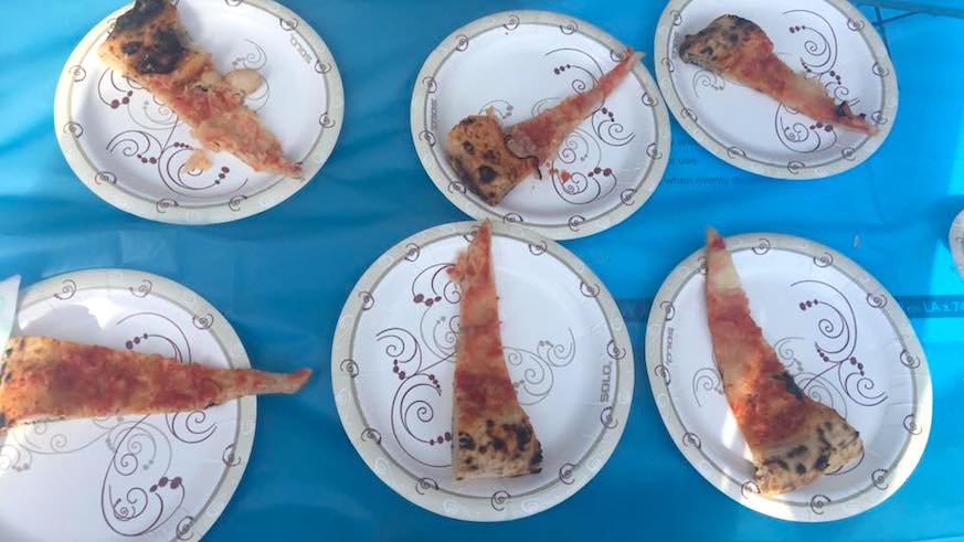 The (cold) pizza slivers — the plates are dessert-sized — served to New York City Pizza Festival Attendees. Credit: Syl Wai, Facebook