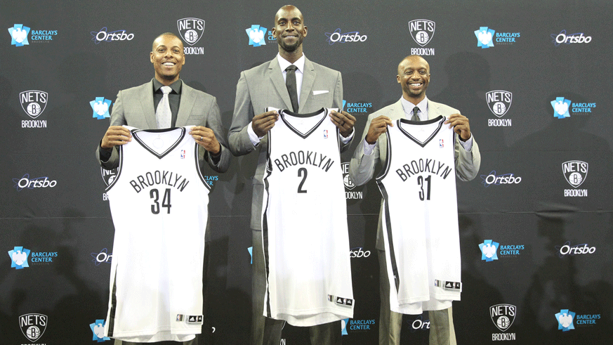 Paul Pierce, Kevin Garnett and Jason Terry pose with their new Nets uniforms during a 2013 introductory press conference. (Photo: Getty Images)