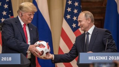 Russian President Vladimir Putin hands U.S. President Donald Trump (L) a World Cup football during a joint press conference after their summit on July 16, 2018 in Helsinki, Finland. Photo: Getty Images