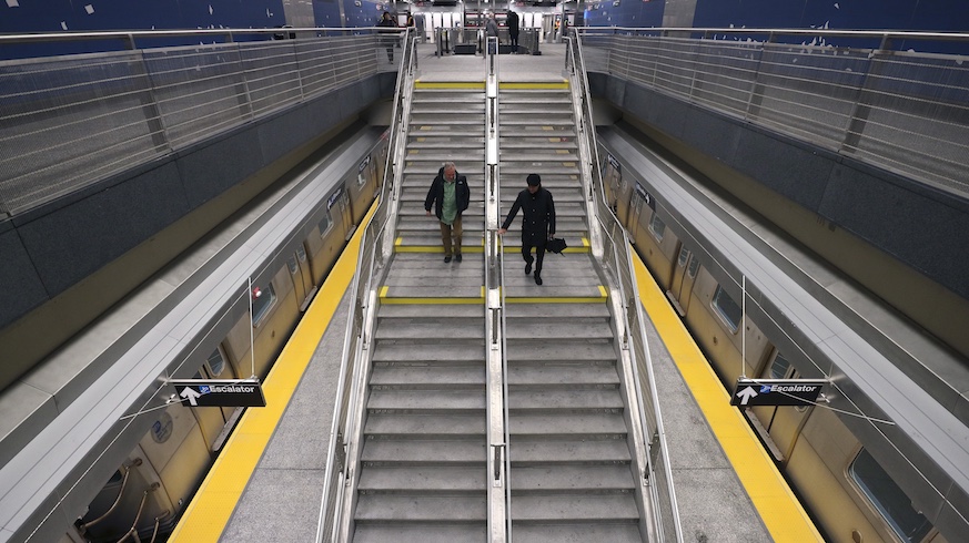 People walk to a waiting train on the platform at the 96th Street station on the Second Avenue subway line on January 3, 2017 in New York City.