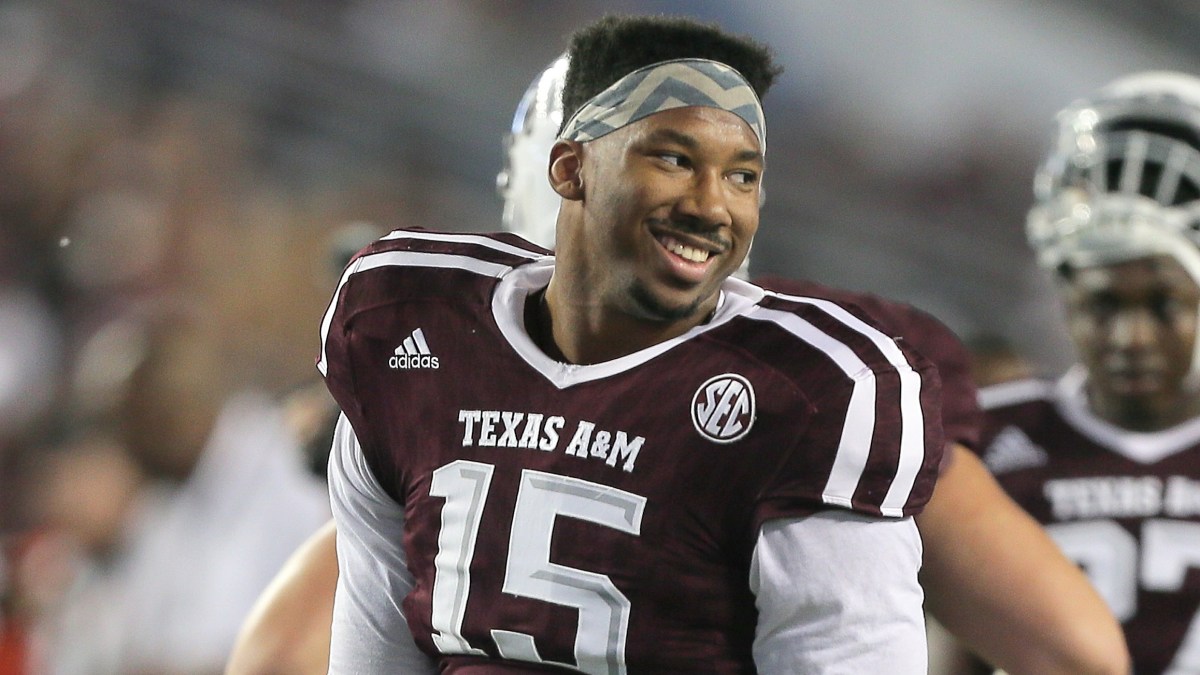 Texas A&M defensive end Myles Garrett jokes with teammates on the sidelines. (Photo: Getty Images)