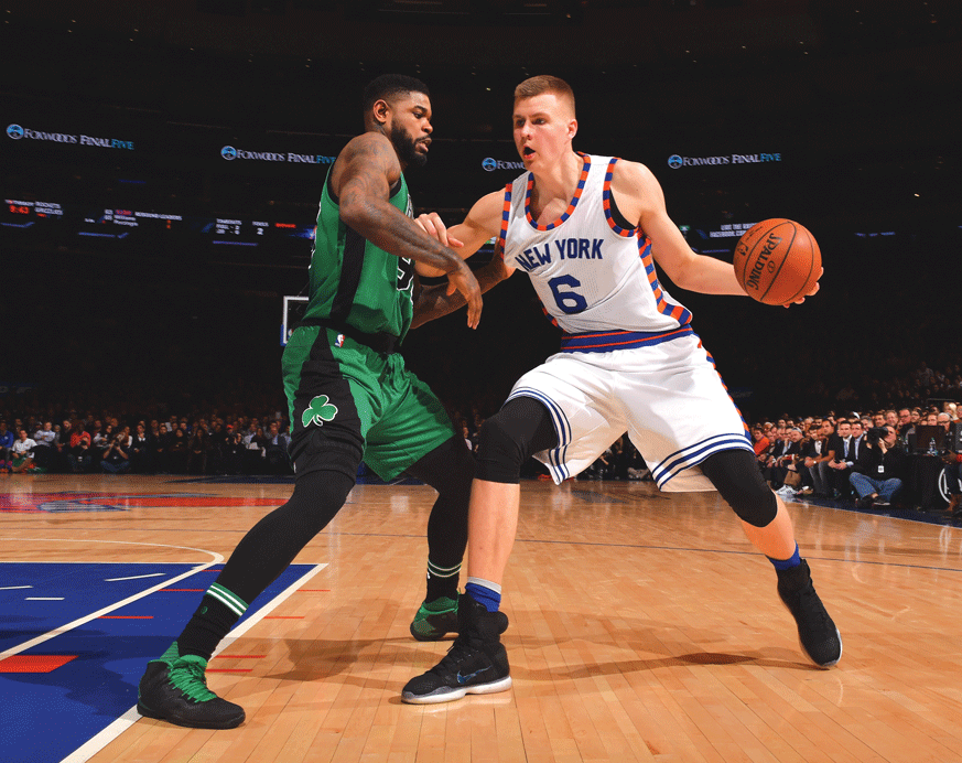 New York Knicks forward Kristaps Porzingis backs down a Boston Celtics defender. (Getty Images)