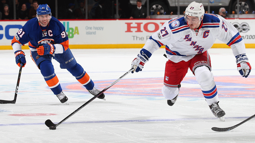Islanders captain John Tavares and Rangers captain Ryan McDonagh chase for a loose puck during a 2017 regular season game. (Photo: Getty Images)