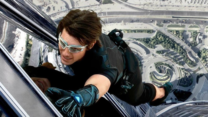 Tom Cruise hanging onto the side of a building