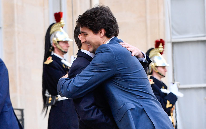Justin Trudeau and Emmanuel Macron hug