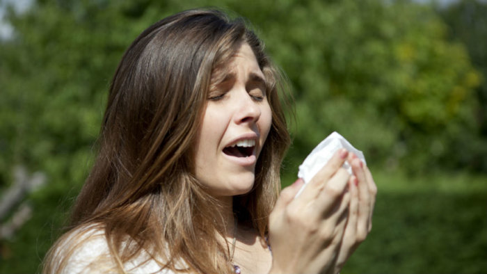 when does allergy season start woman sneezing