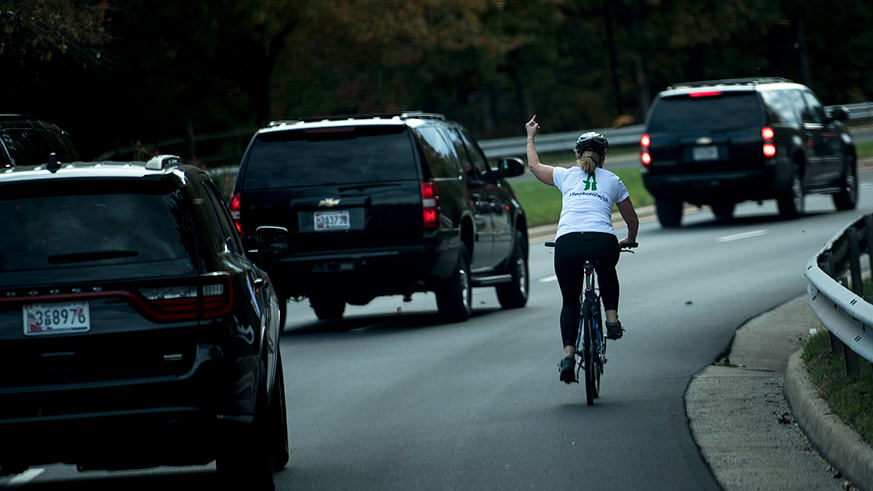 Juli Briskman gives middle finger to Trump's motorcade.