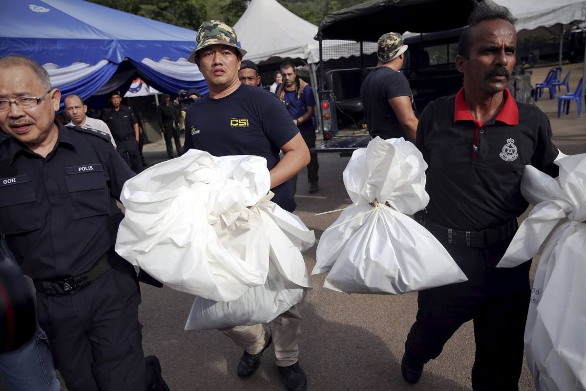 Malaysia police start exhuming bodies from migrant mass graves