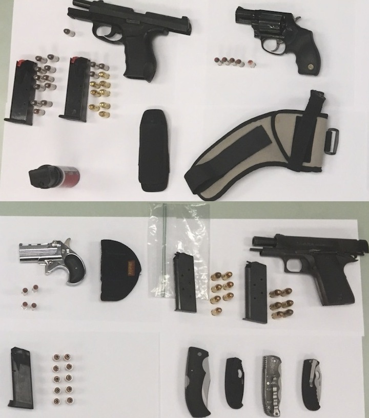 Man found with firearms, knives after stopped for talking on phone while