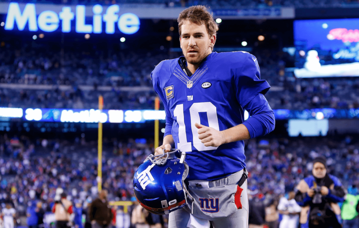 Eli Manning runs off the field after a 2016 game. (Getty Images)