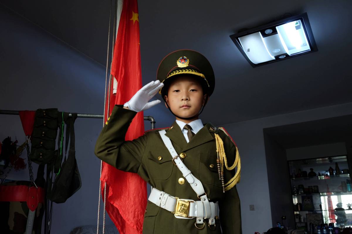 China’s ‘national flag baby’ raises flag, captivates millions