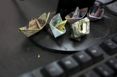 Bolivar boats, bills in bras as Venezuela’s currency sinks